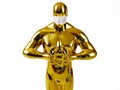 Hollywood Golden Oscar Academy award statue in medical mask. Success and victory concept. Oscar ceremony in coronavirus time