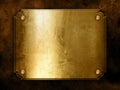 Golden metal plate on concrete wall Royalty Free Stock Photo