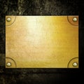 Golden metal plate on concrete wall Royalty Free Stock Photo