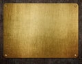 Golden metal plate with rivets on grunge background. 3d illustration Royalty Free Stock Photo