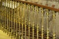 Golden metal railings on a marble staircase of an old stately building