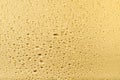 Golden metallic foil texture with water drops as background Royalty Free Stock Photo