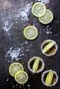 Golden mexican tequila shot with green lime and salt