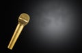 Golden microphone on black background