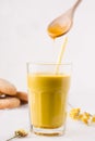 golden milk in which honey Royalty Free Stock Photo