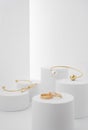 Golden Modern bracelets on white paper platforms Royalty Free Stock Photo