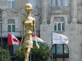 Golden modern stylized sculpture in front of the Grescham Palace to Budapest in Hungary.