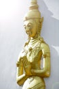 Golden monk statue press the hands together at the chest or fore Royalty Free Stock Photo