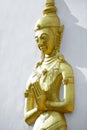 Golden monk statue press the hands together at the chest or fore Royalty Free Stock Photo