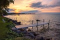 Golden moody light on a lakeside dock at sunset. Royalty Free Stock Photo