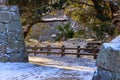 Golden morning light by ancient stone walls and snow covered walking path Royalty Free Stock Photo