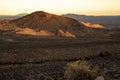 Golden morning light on red earth hills, mountains, Eastern Sierra Nevadas, California