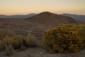 Golden morning light on red earth hills, mountains, Eastern Sierra Nevadas, California