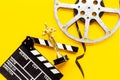 Golden movie award statue with film reel video tape and clapper board Royalty Free Stock Photo