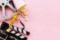 Golden movie award statue with film reel video tape and clapper board Royalty Free Stock Photo