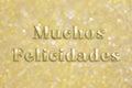 Golden `Muchos Felicidades` text on festive background