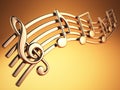 Golden music notes and treble clef on musical strings on yellow Royalty Free Stock Photo