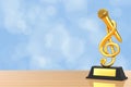 Golden Music Treble Clef with Microphone Award Trophy. 3d Rendering Royalty Free Stock Photo