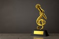 Golden Music Treble Clef with Microphone Award Trophy. 3d Rendering Royalty Free Stock Photo