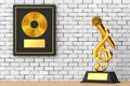 Golden Music Treble Clef with Microphone Award Trophy and Golden Vinyl or CD Prize Award with Label in Black Frame . 3d Rendering Royalty Free Stock Photo