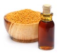 Golden mustard on a wooden pot with oil Royalty Free Stock Photo