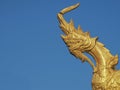 Golden Naga or Serpent King statue in buddhist temple.