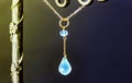 Golden necklace with apatite with green chalcedony with blue topaz on black background.