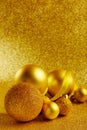 Golden New Year tree toys with glitter background. Xmas decorations. Winter holidays backdrop with copyspace. Christmas