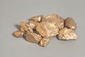 Golden nuggets on gray Royalty Free Stock Photo