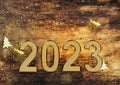 2023 golden numbers on rustic wooden background