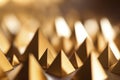 Golden objects of a pyramid shape in an artistic pattern. Ai generated Royalty Free Stock Photo