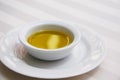 Golden Olive Oil on White Tablecloth