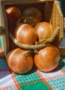 Golden onions in a wooden box