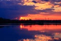 Dramatic sunset on the water with symmetry of colorful clouds cumulonimbus Royalty Free Stock Photo