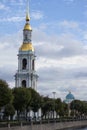 Golden orthodox church dome bell tower on a cloudy blue sky