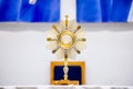 Golden Ostensory or Monstrance for worship at a Catholic church ceremony in detailed view.