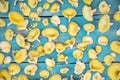 Golden oyster mushrooms on blue wooden table, yellow fungi background