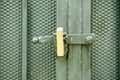 Golden padlock keeping locked black metal door. Royalty Free Stock Photo