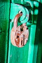 Golden padlock on old green wooden door closet Royalty Free Stock Photo