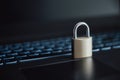 A golden padlock placed on laptop computer keyboard