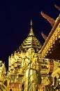 Golden Pagoda and buddhist statue Royalty Free Stock Photo