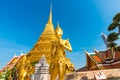 Golden pagoda with giant statue at Royal grand palace temple Royalty Free Stock Photo