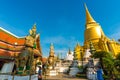 Golden pagoda with giant statue at Royal grand palace temple Royalty Free Stock Photo