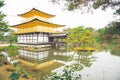 Golden pagoda with green tree and reflection on lake in autumn a Royalty Free Stock Photo