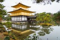 Golden pagoda with green tree and reflection on lake in autumn a Royalty Free Stock Photo