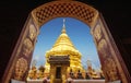 Golden pagoda view through from ancient door architrave arch at Wat Phra That Doi Suthep temple. popular famous tourist temple