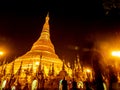 The golden pagodas and mondops are illuminated in the light of the night