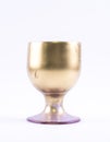 Golden painted, elegant glass on a white background