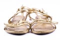 Golden painted, elegant, party shoes on a white background - front Royalty Free Stock Photo