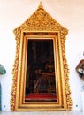 Golden painting stucco door frame, Thai ancient temple.